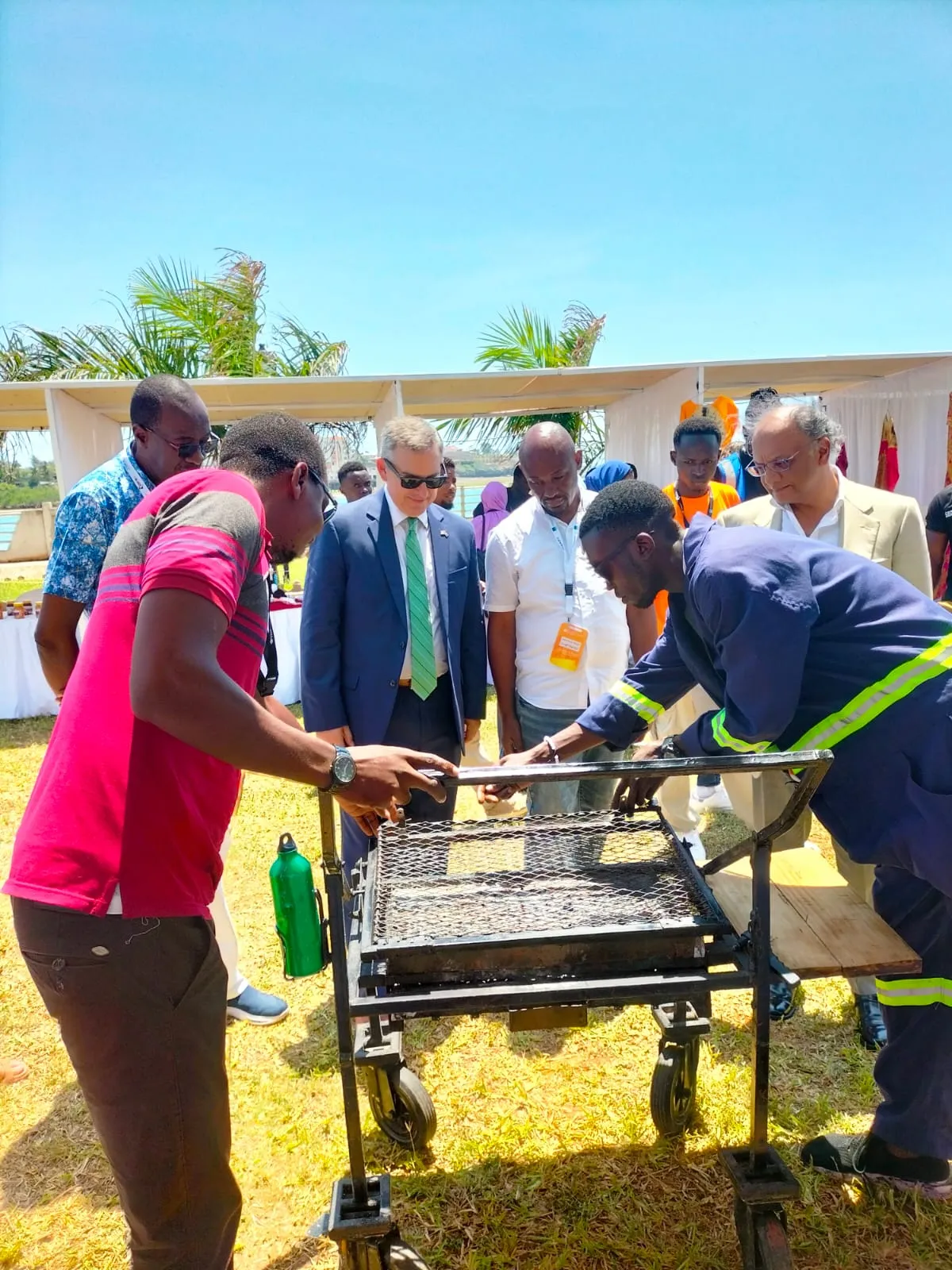Beka demonstrating a mobile custom metal construction to a group